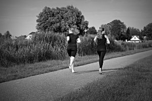 Beginners course - Two ladies run together through a park